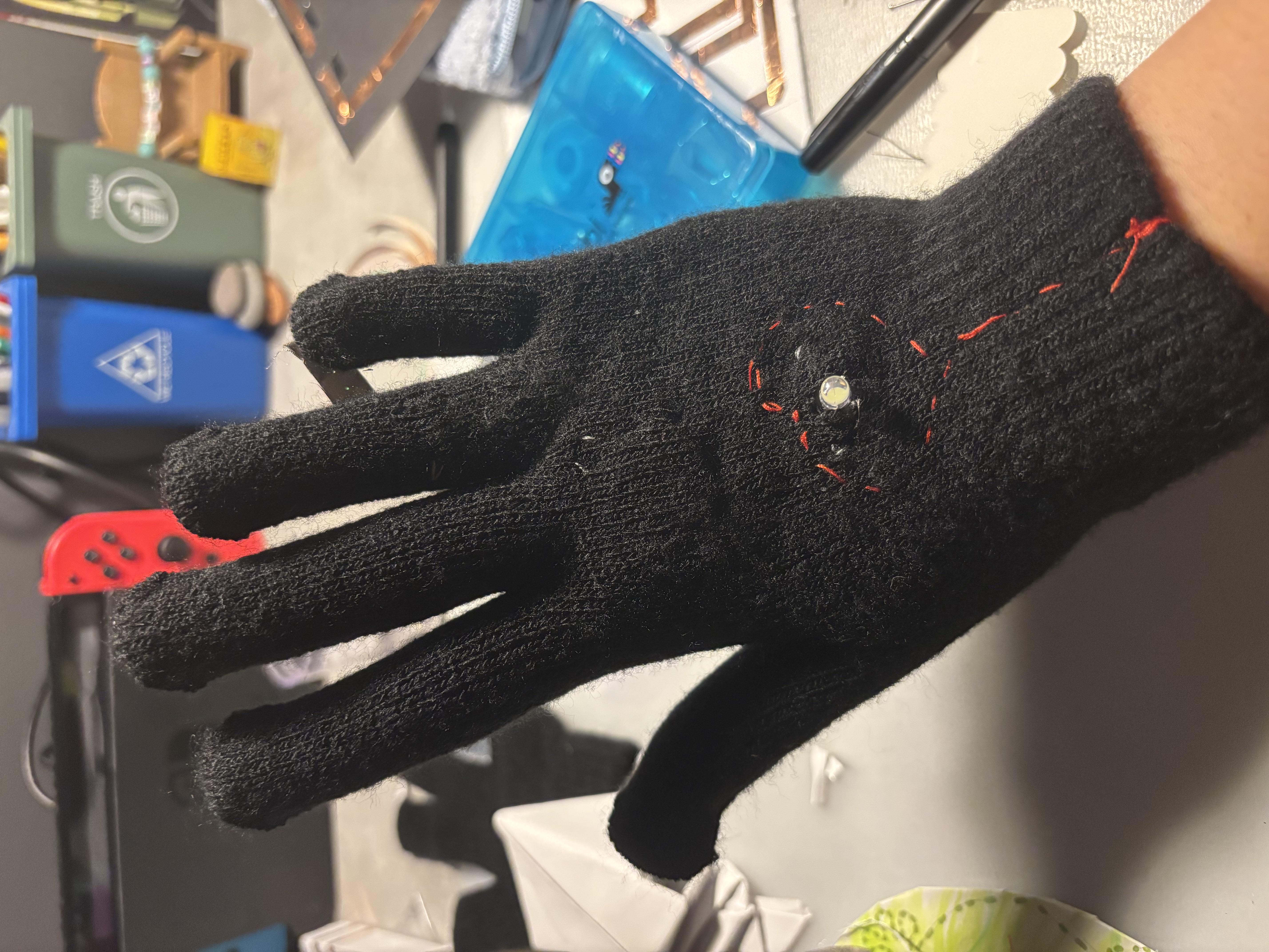 Wearable: circuit closes with a ring on the ring finger inside the glove with an LED light in the middle of a heart.